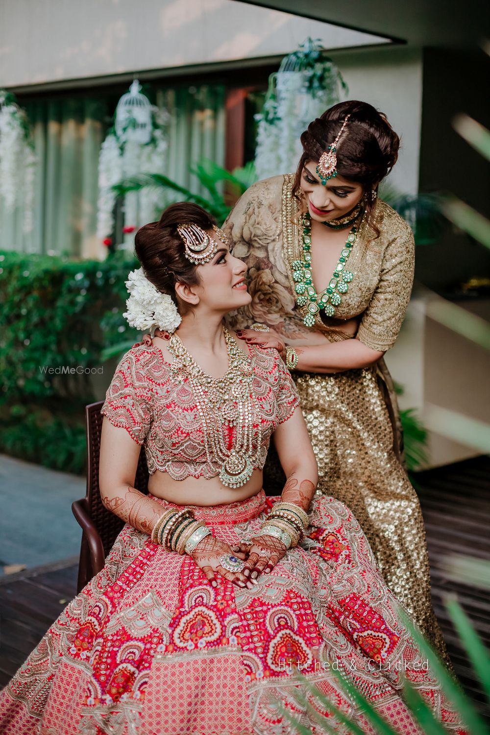 Photo of A candid shot of the bride and her bridesmaid