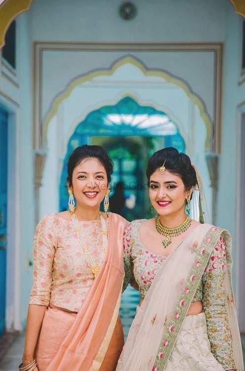 Photo of Bride with sister in offbeat lehenga