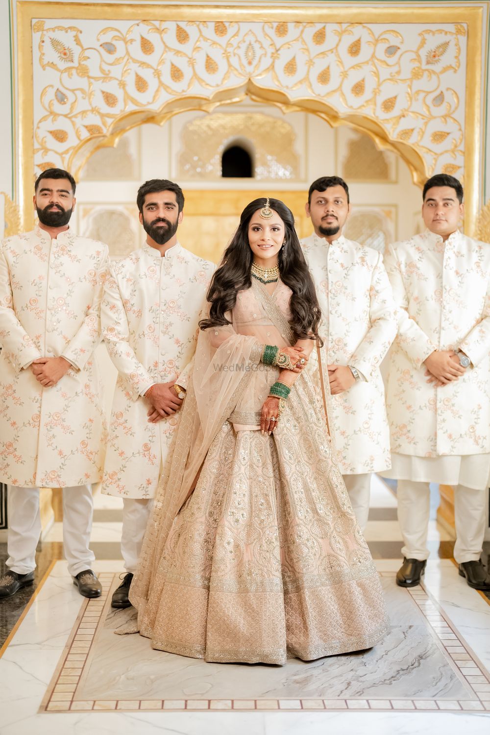 Photo of bride with bridesmen all wearing pastels
