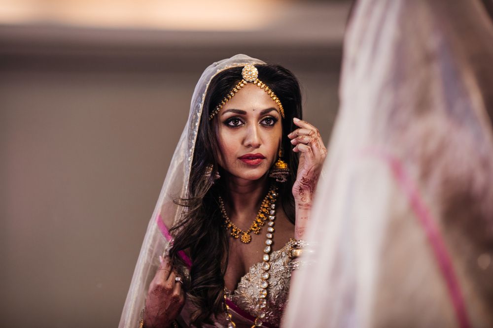 Photo of Bridal portrait looking in mirror