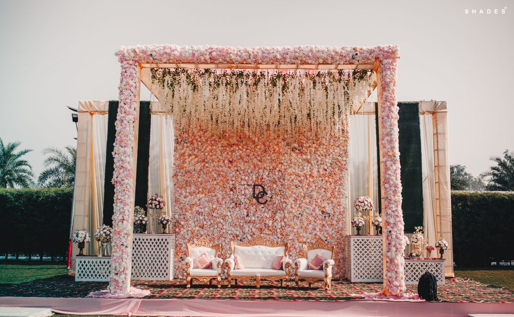 Photo of Artistic floral stage decor for the bride and groom.