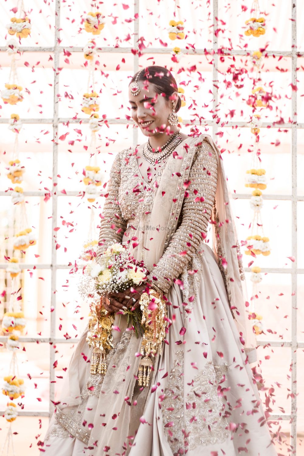 Photo of Pretty bridal portrait with petals thrown