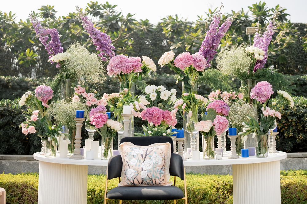 Photo of Breathtaking floral arrangements in purple and pink florals for a table set up