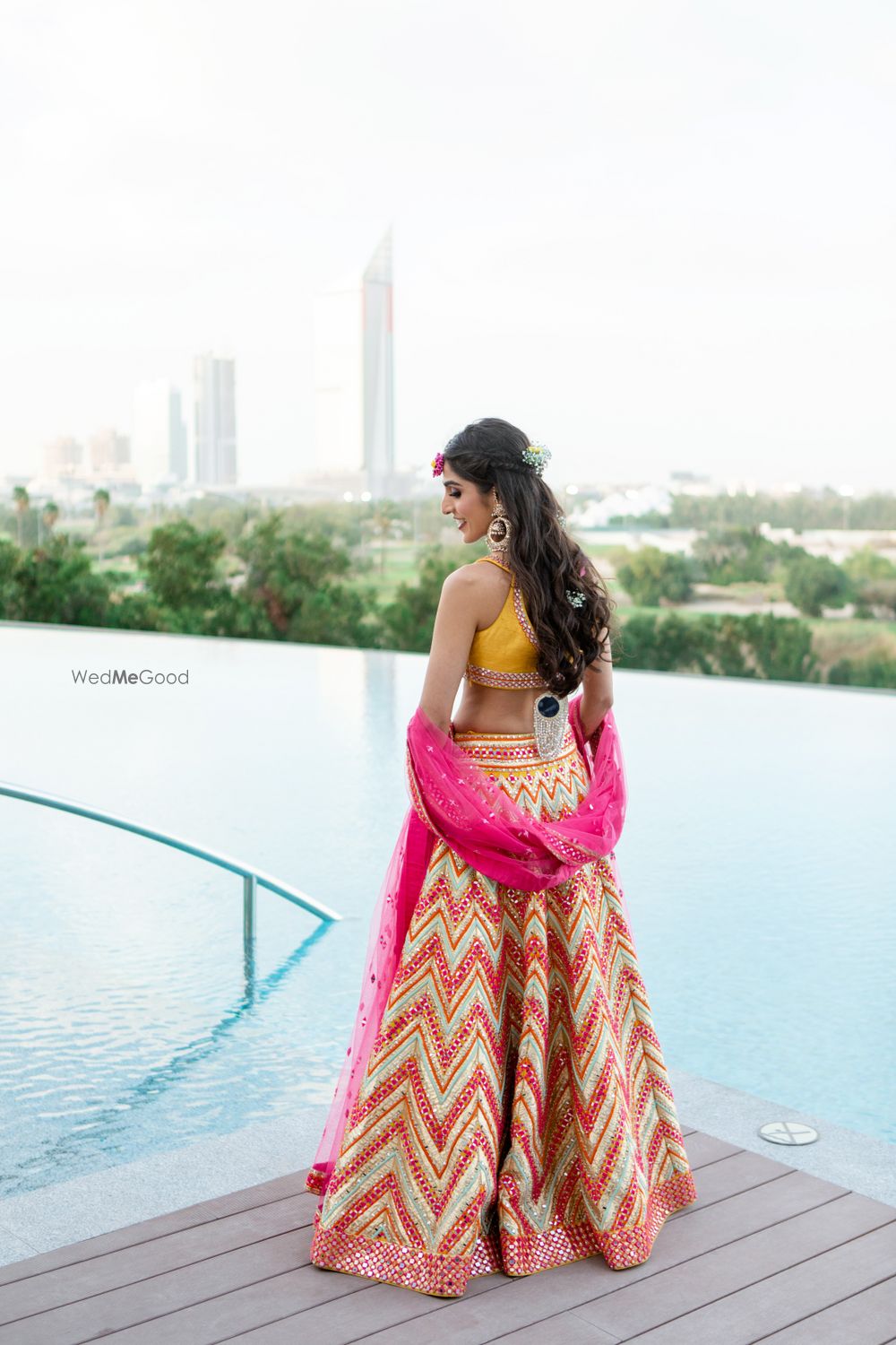 Photo of Bride wearing chevron print lehenga with mirror work.