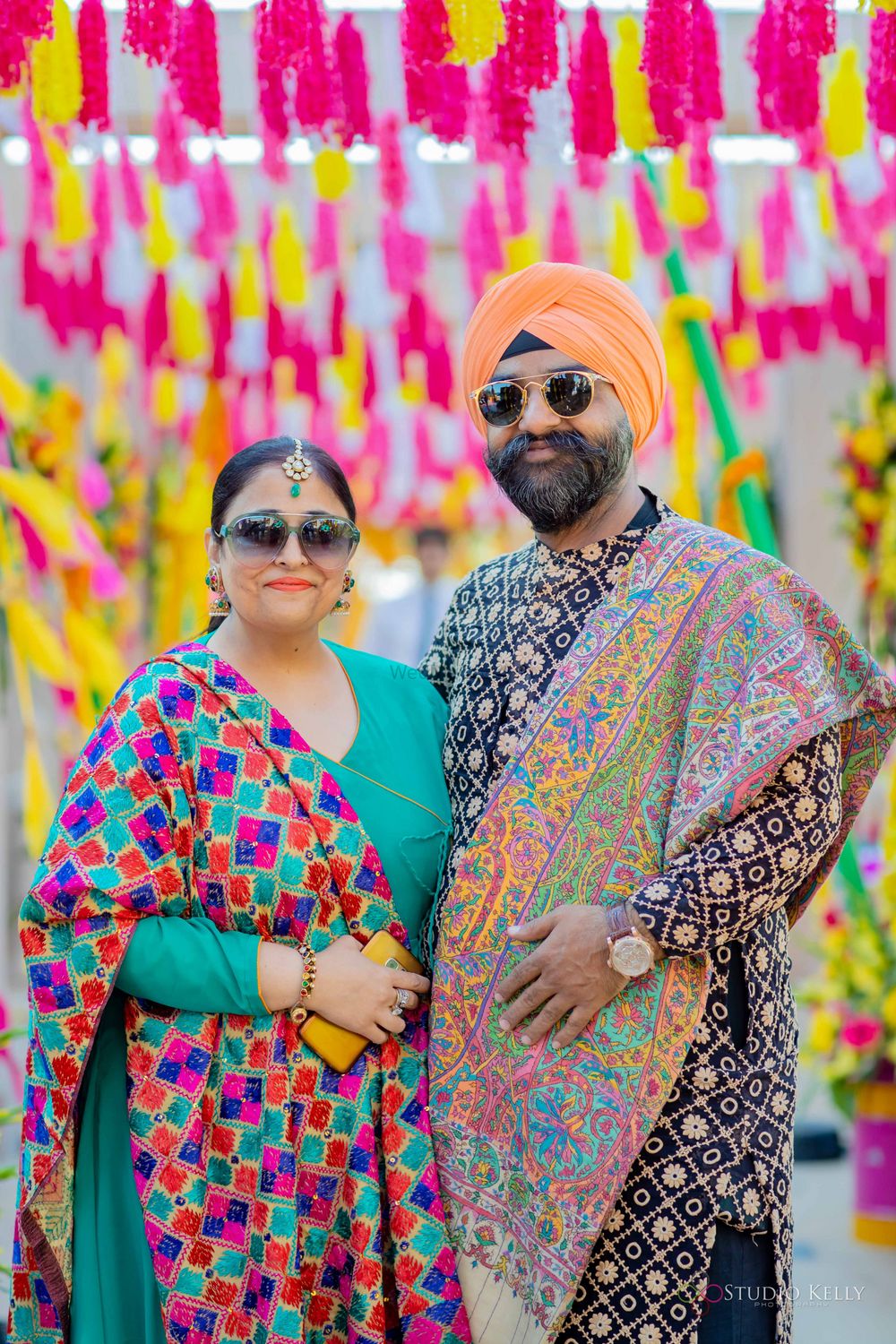Photo of parents of the bride in phulkari outfits