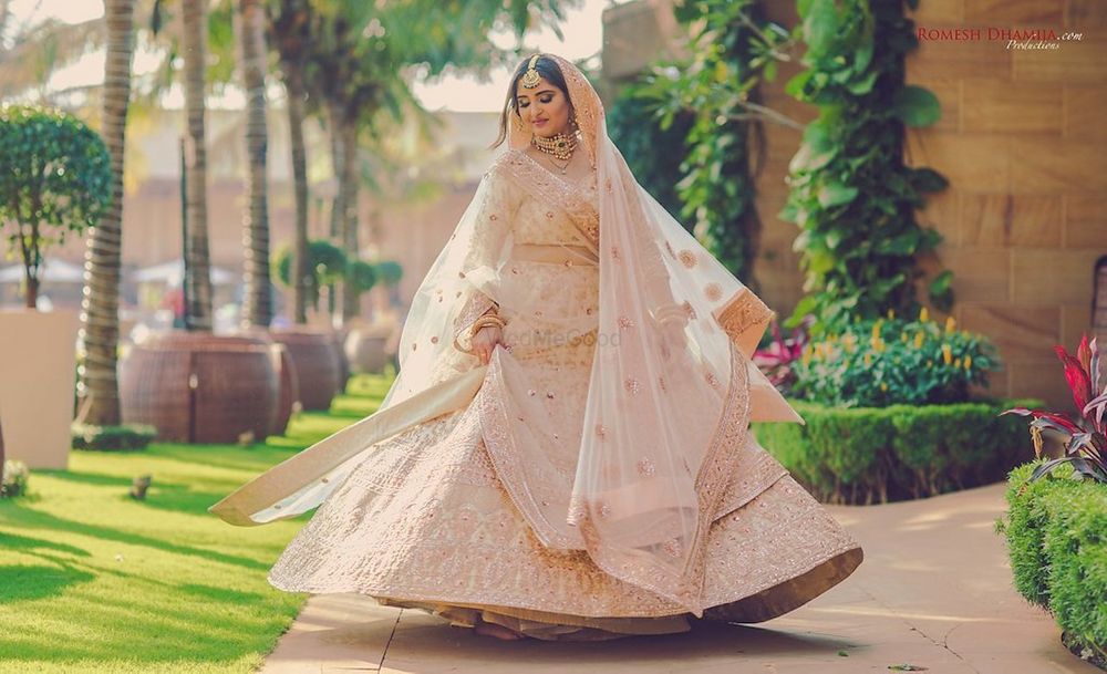 Photo of Twirling bride in light peach lehenga