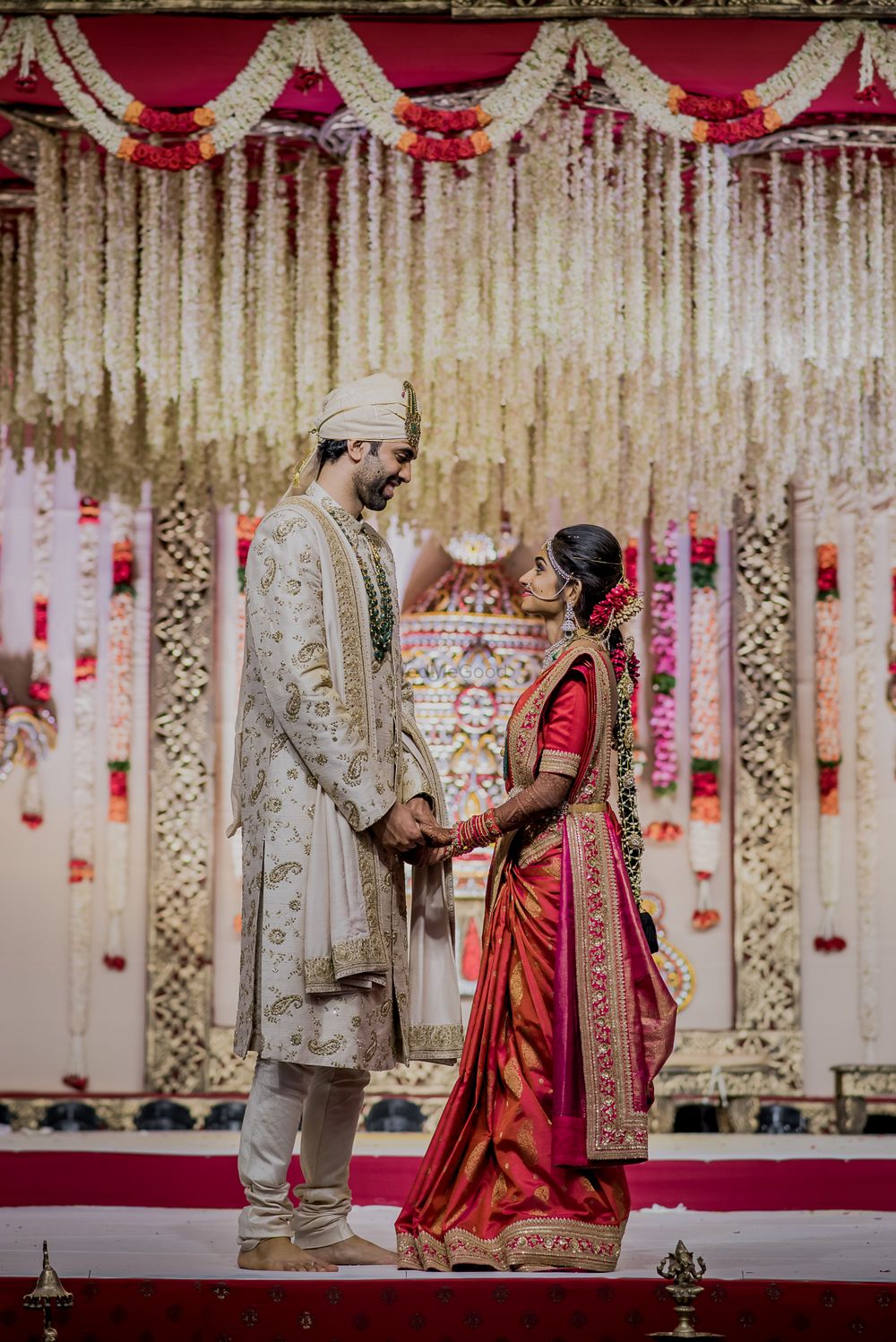 Photo of A south indian bride and groom pose in coordinated outfits