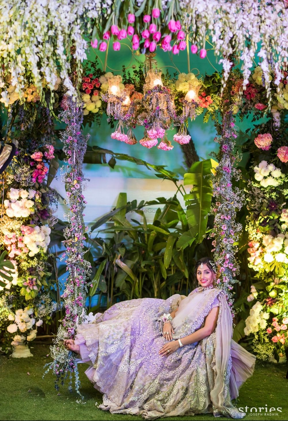 Photo of Floral mehendi photobooth with swing and bride
