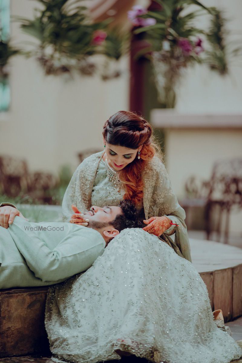 Photo of Cute couple portrait idea with groom on brides lap