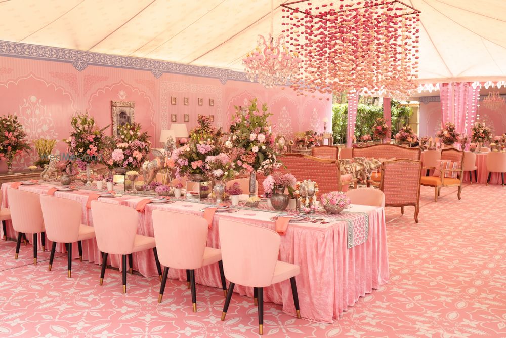 Photo of Stunning all-pink decor with floral centerpieces and hanging floral decor with pink chairs