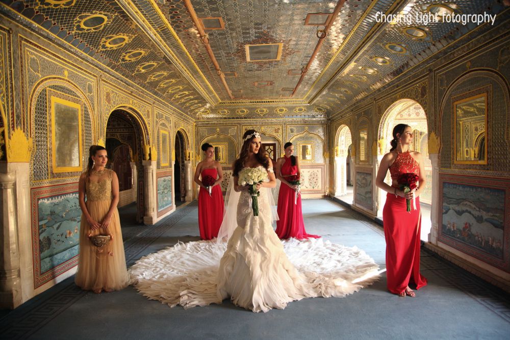 Photo of Bridesmaids with Bride wearing Gown with Train
