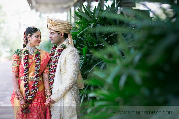 Photo of South Indian Couple Holding Hands Wearing Var Mala