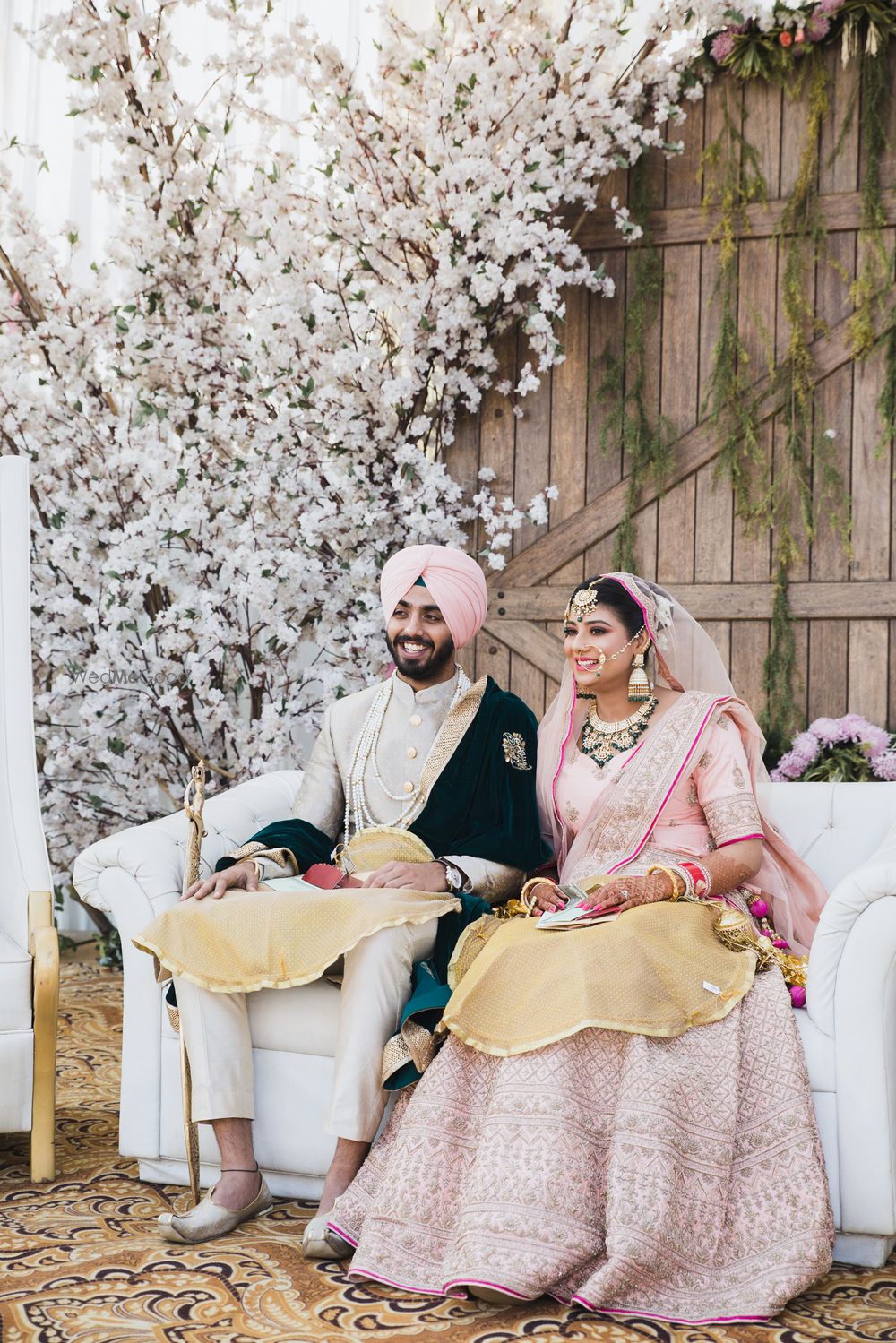 Photo of Coordinated sikh bride and groom in pink outfits