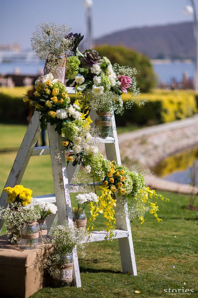 Photo of Wooden ladder with floral arrangements