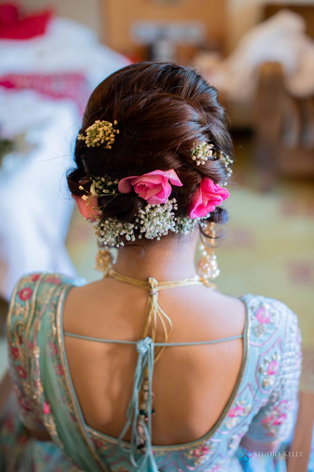 Photo of bright pink bridal bun with flowers