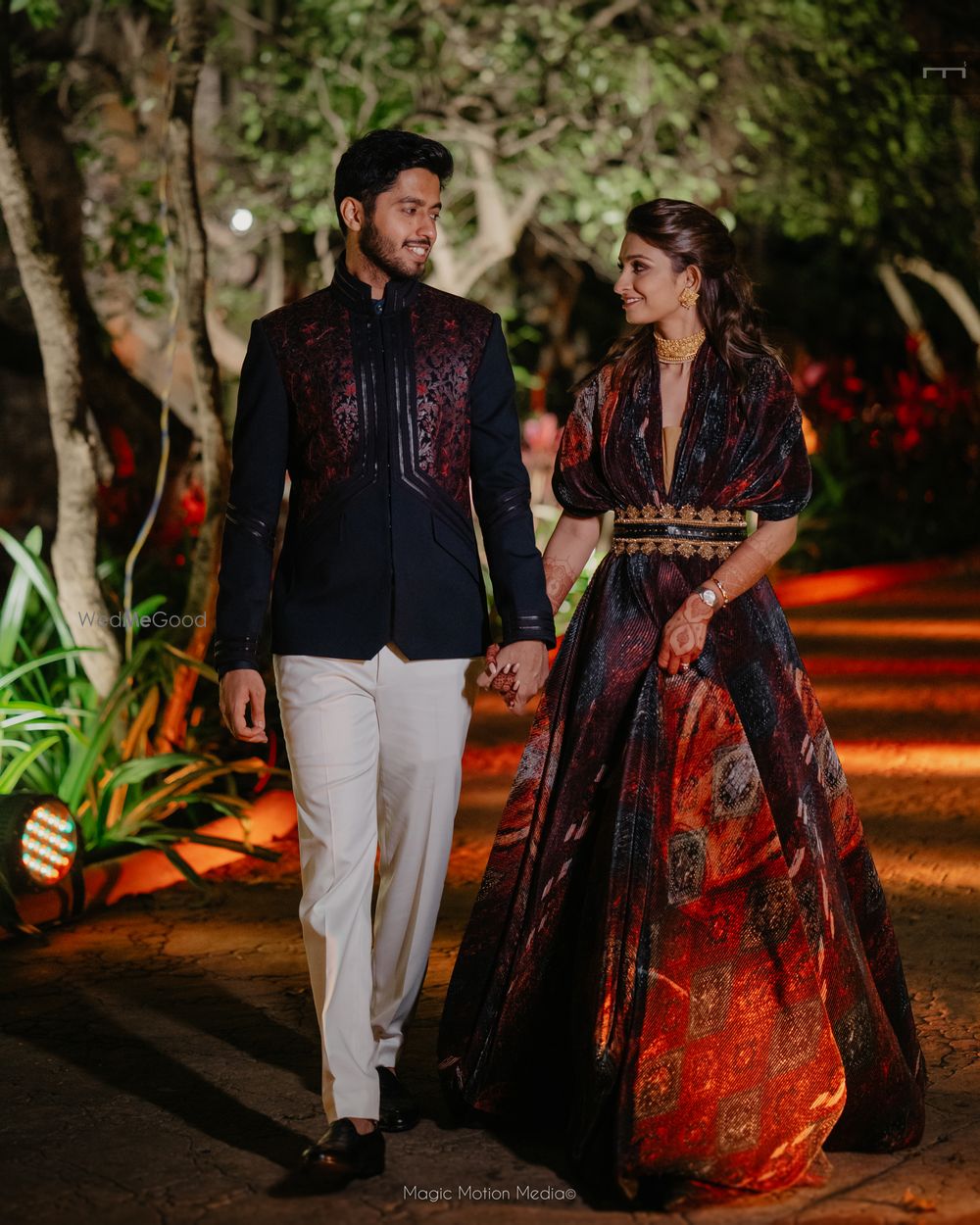 Photo of Stunning couple entry capture with bride and groom in co-ordinated outfits