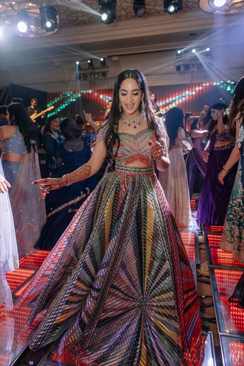 Photo of technicolour amit aggarwal cocktail outfit on bride