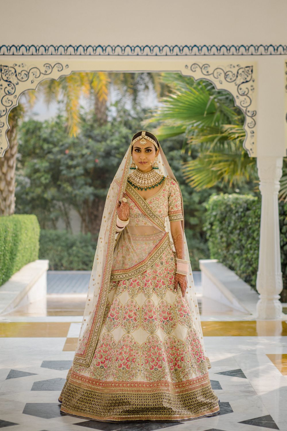 Photo of Bride dressed in an ivory lehenga on her wedding day.