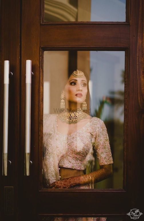 Photo of Engagement portait of bride looking out of the window
