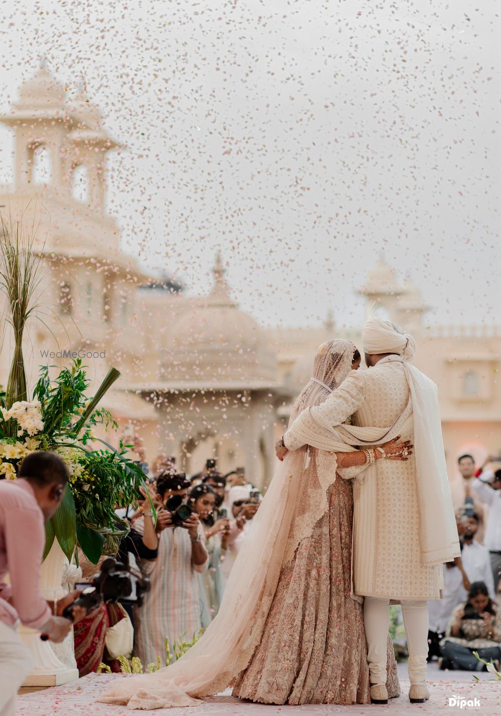 Photo of Gorgeous shot of the just married couple hugging amongst confetti burst