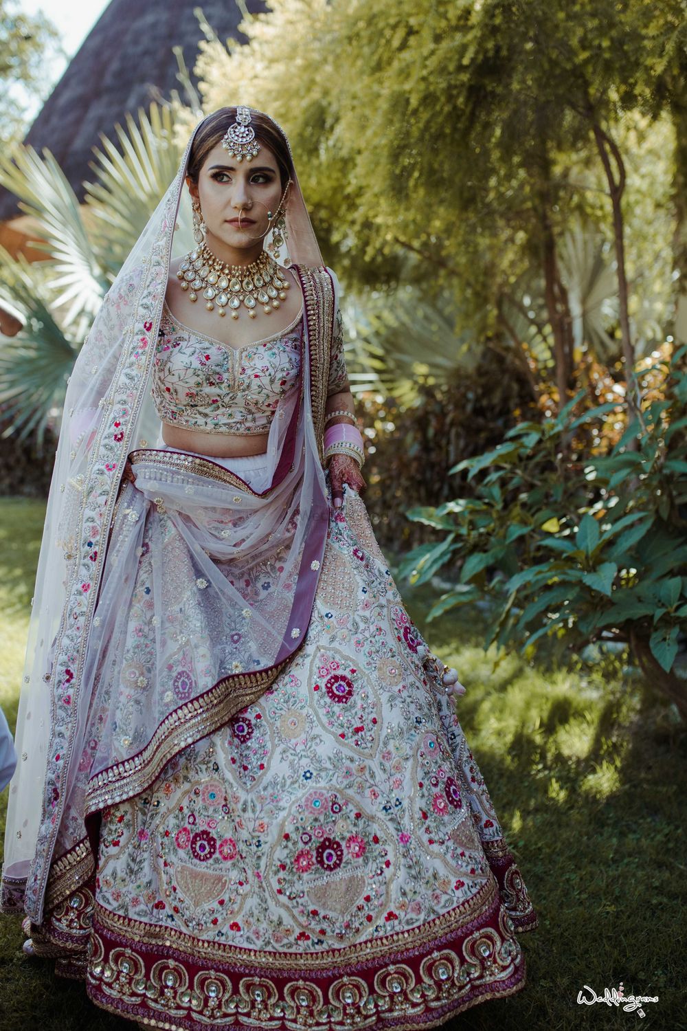 Photo of offbeat floral bridal lehenga in white and maroon