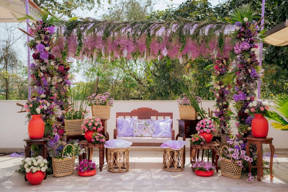 Photo of Beautiful lavender and green outdoor mehendi set up with cane baskets and floral decor