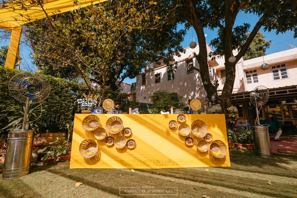 Photo of Yellow bar décor for a Mehendi function at bride's home backyard.