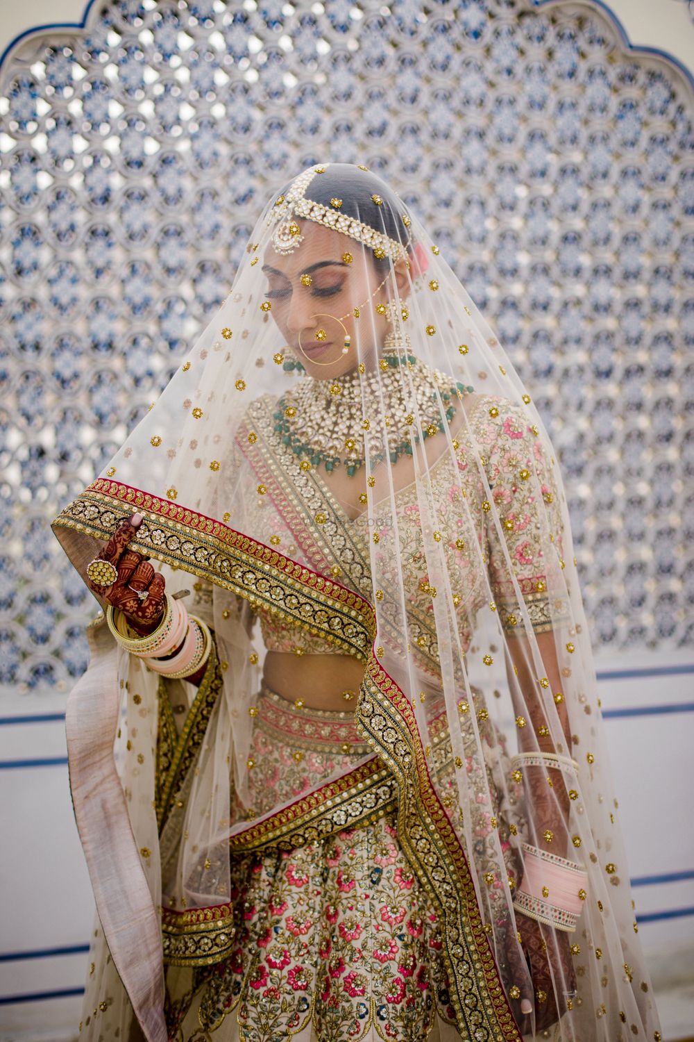 Photo of Bride in floral lehenga and net veil dupatta