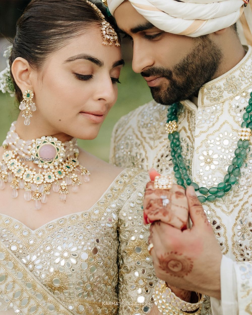 Photo of Unique layered jewellery in polki and jadau and groom wearing emerald necklace