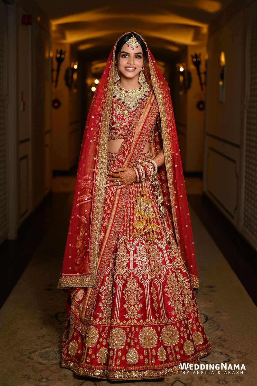 Photo of bride in traditional red and gold bridal lehenga with double dupatta