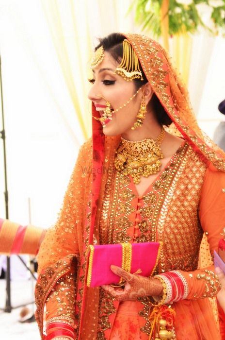Photo of Candid Bride in Orange Anarkali by Sabyasachi