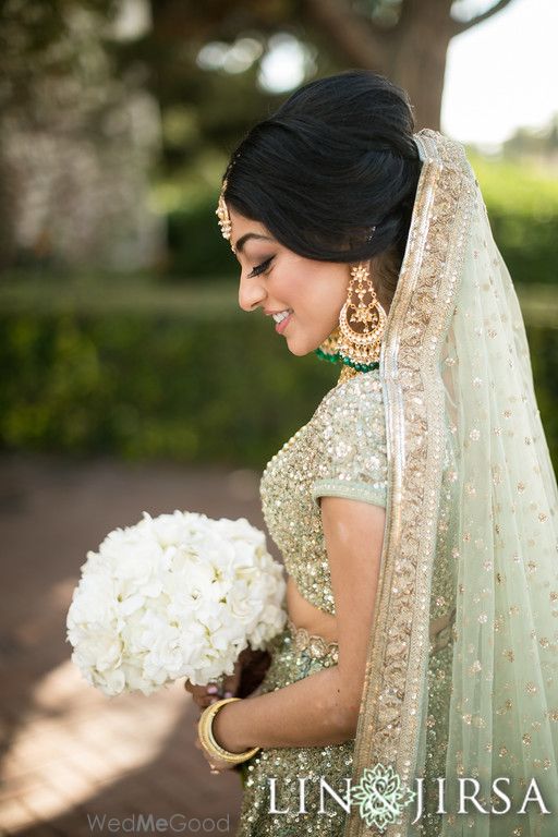 Photo of Shy bride portrait in light green lehenga