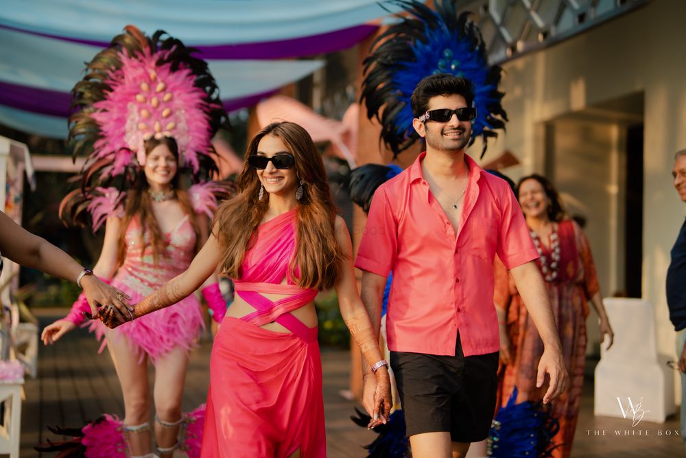 Photo of Fun couple entry idea for their mehendi party with the couple coordinated in pink!