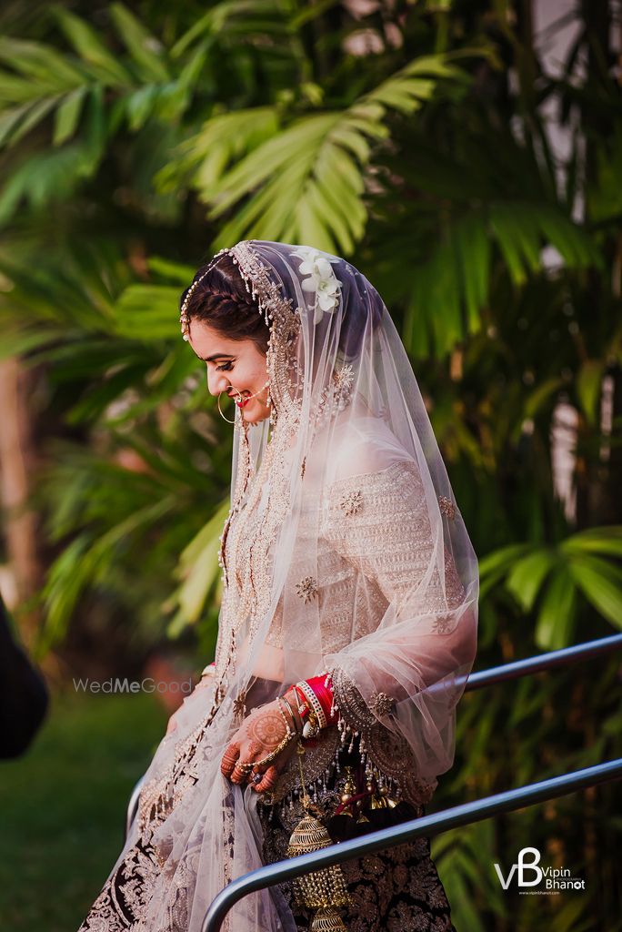 Photo of Happy bride side shot while entering