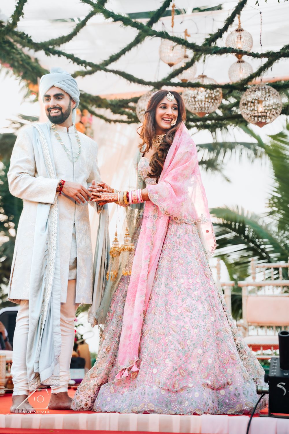 Photo of Bride and groom in pastel wedding outfits