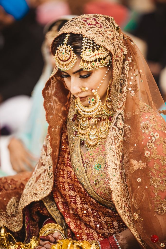 Photo of A bride wearing stunning gold jewelry in vintage designs