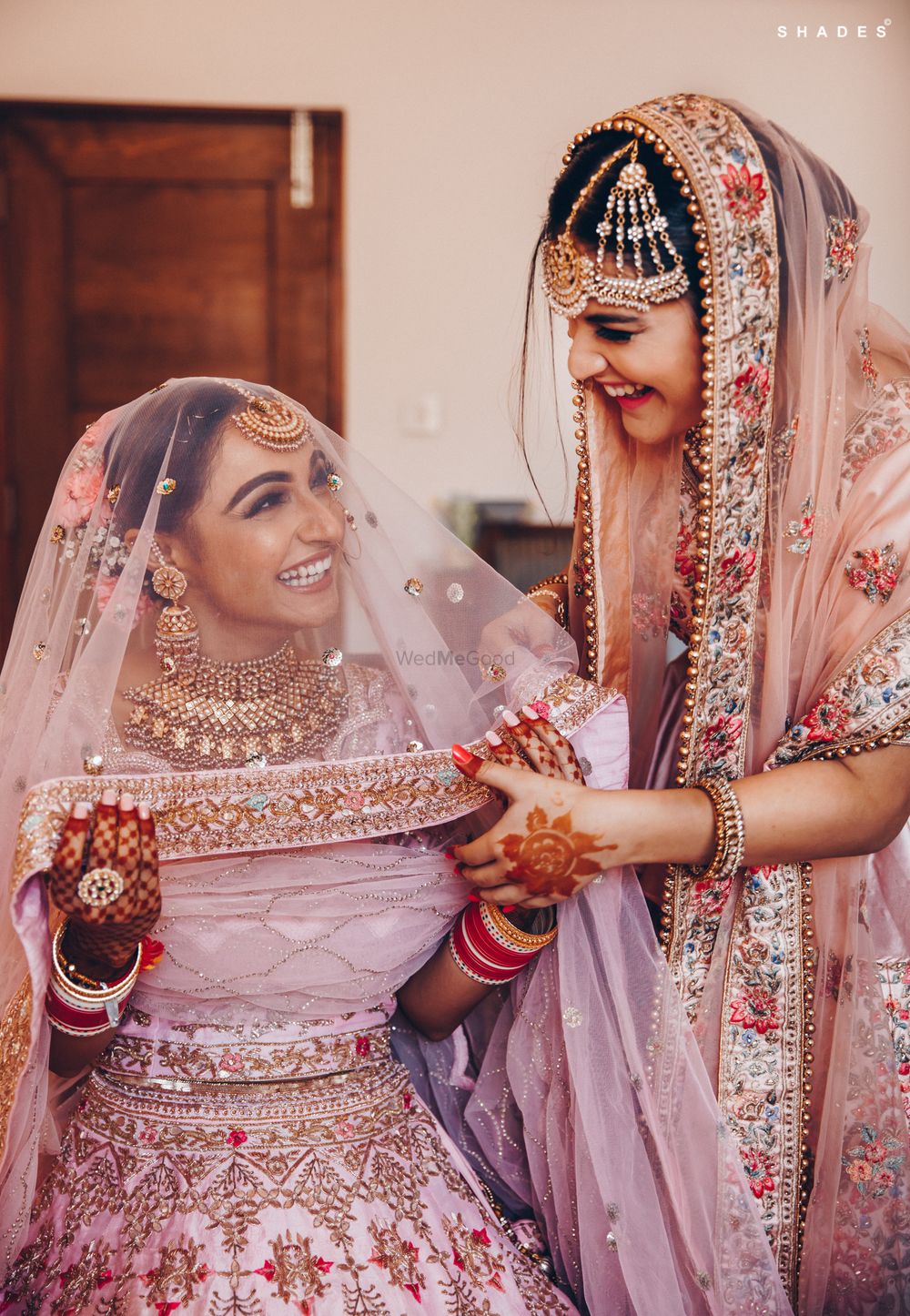 Photo of A bride getting ready with the help of her sister