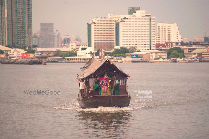 Photo of Bride entry on a shikara from across the lake