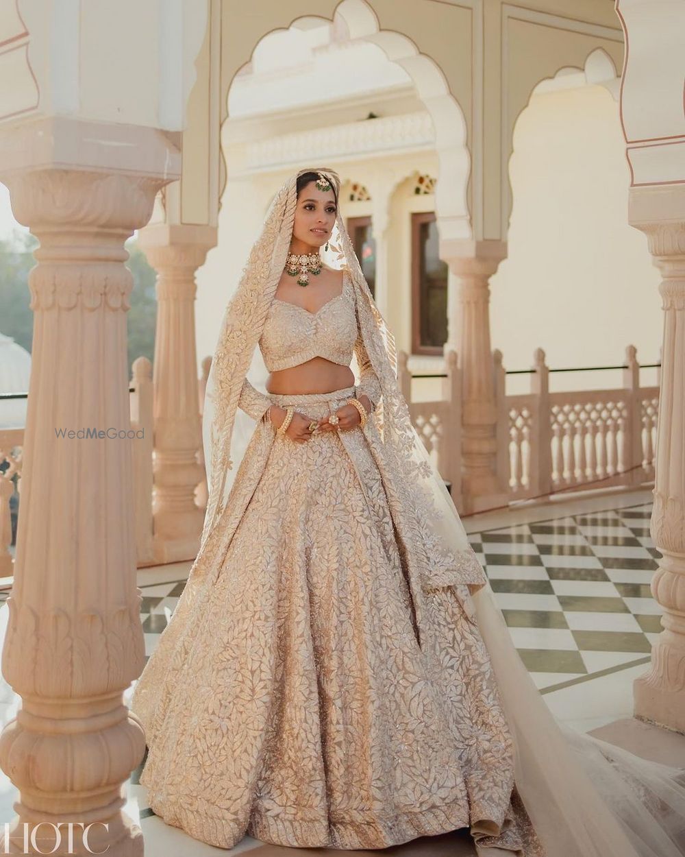 Photo of Classic bridal portrait with the bride wearing a stunning white and gold lehenga on her wedding day