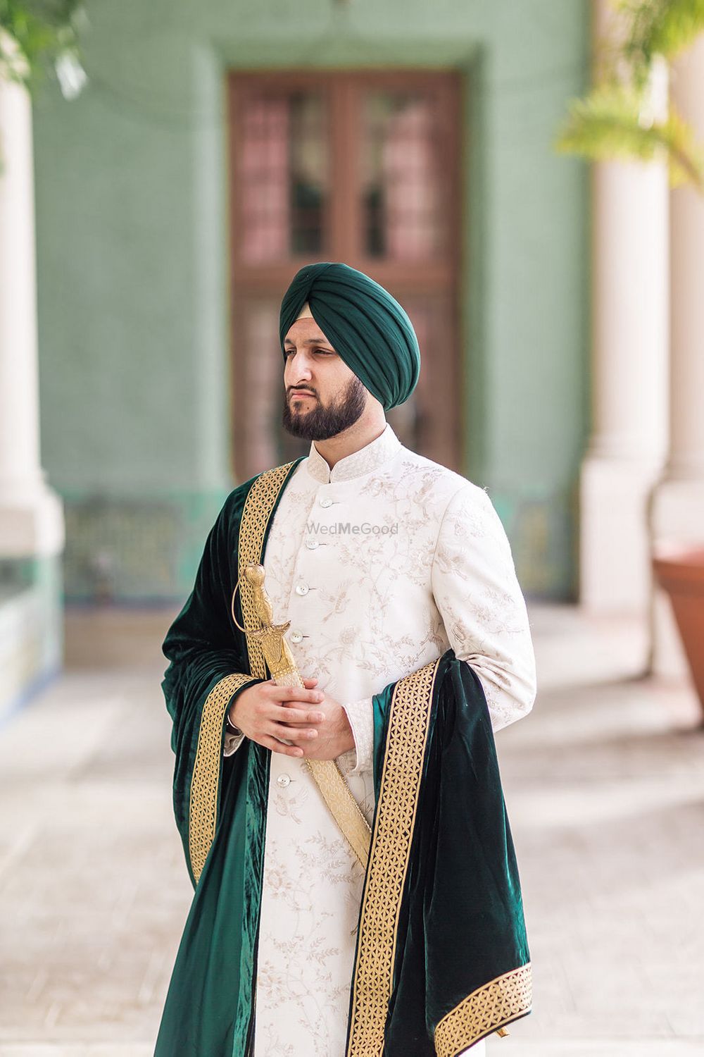 Photo of Sikh groom with velvet stole and sword