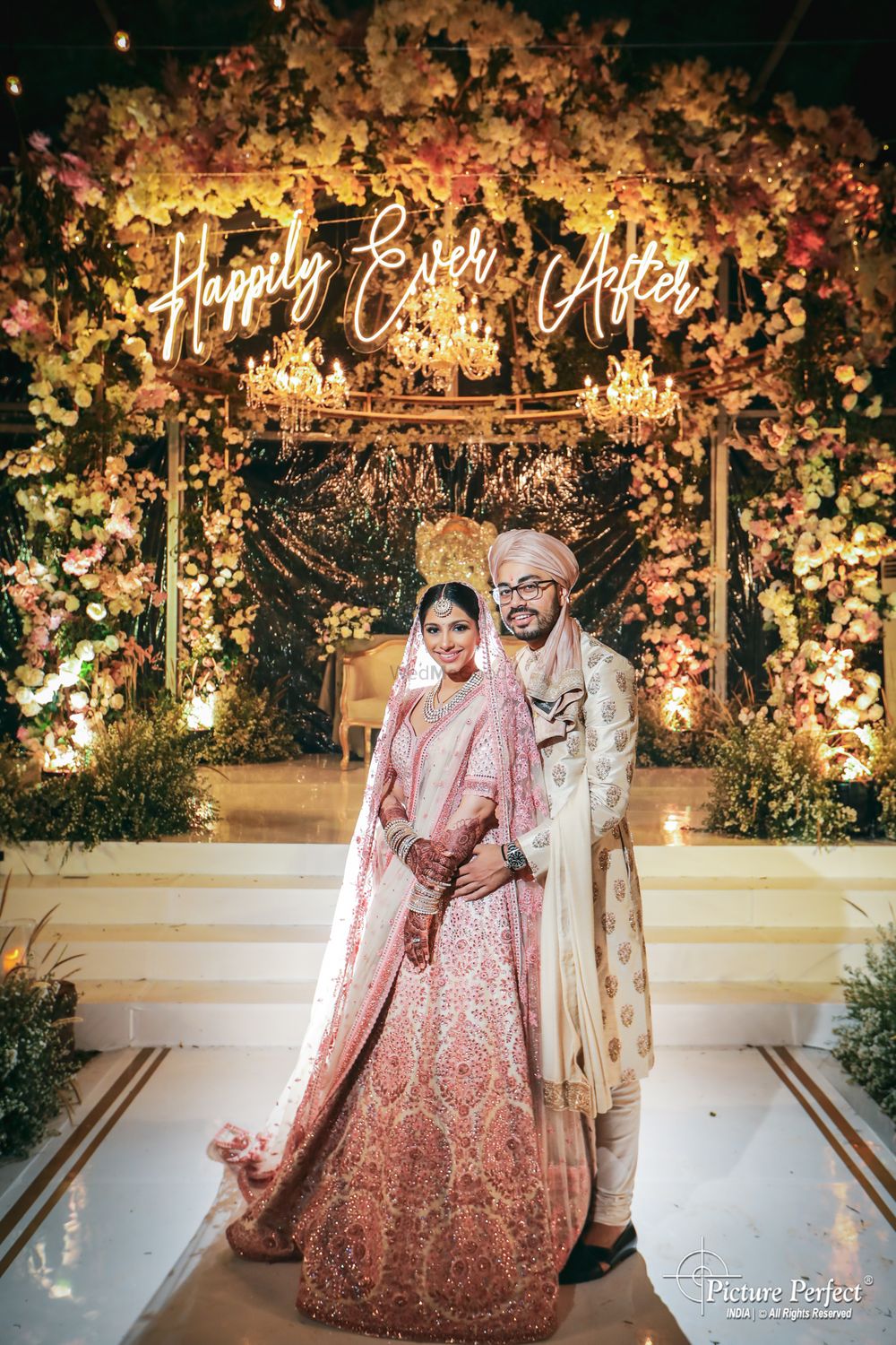 Photo of wedding day couple pose idea against unique mandap