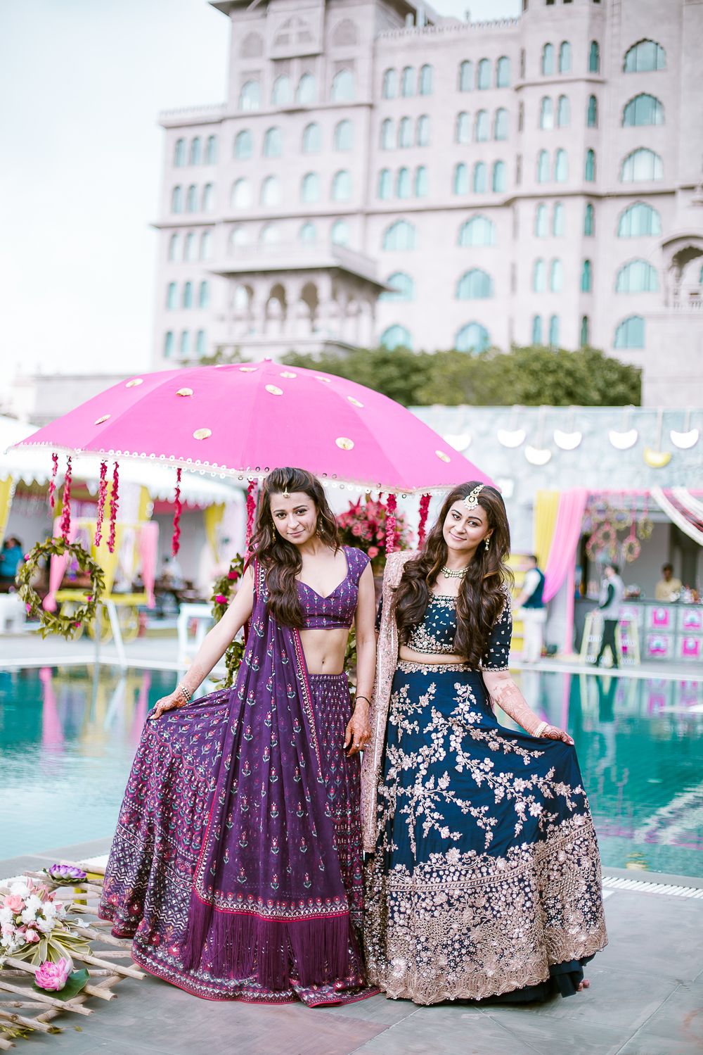 Photo of Sister of the bride in purple and teal lehengas