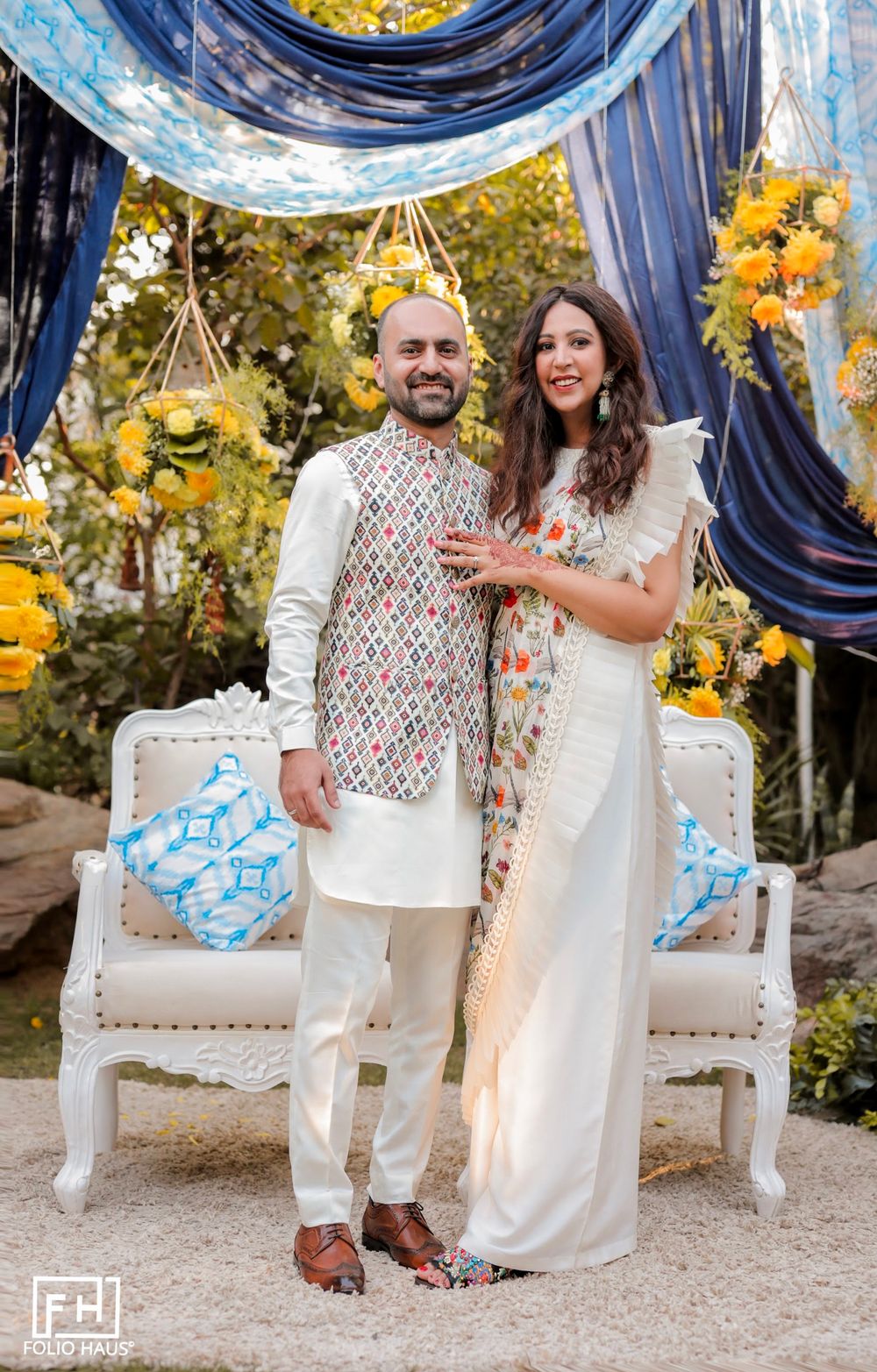 Photo of The couple on their engagement party with the bride in a white ruffle saree!