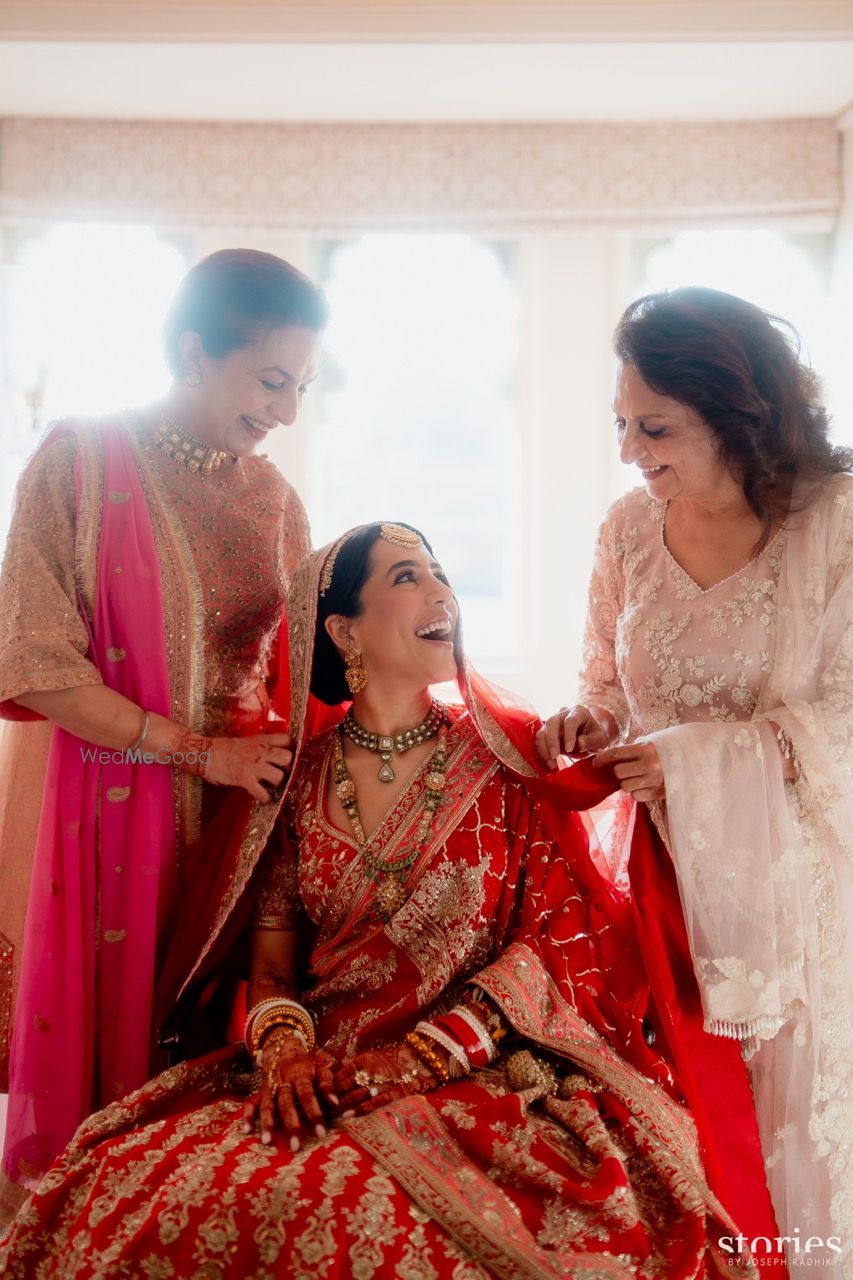 Photo of Lovely candid shot of the bride with the mother of the bride and mother of the groom