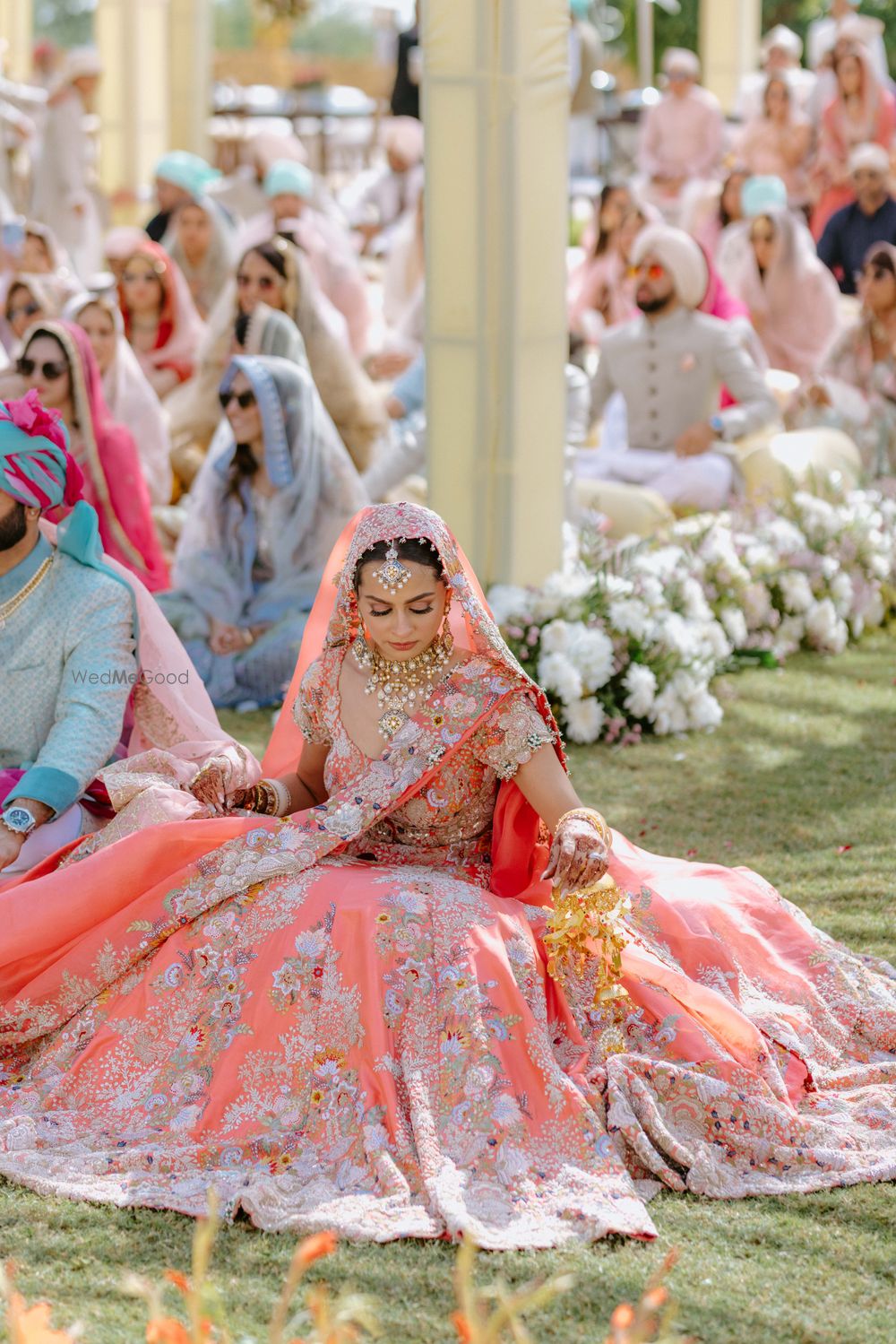 Photo of Bridal portrait in coral lehenga on Anand Karaj