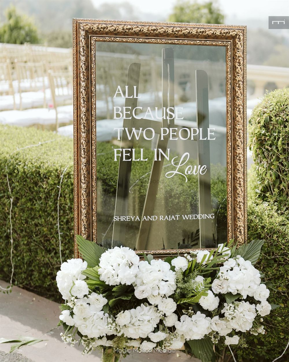 Photo of Lovely signage in mirror style with white and green florals for the entrance