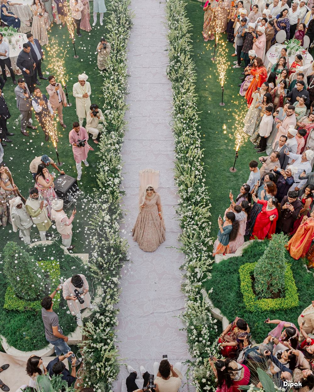 Photo of Top view shot of the bride making her wedding entry alone as she walks down the aisle