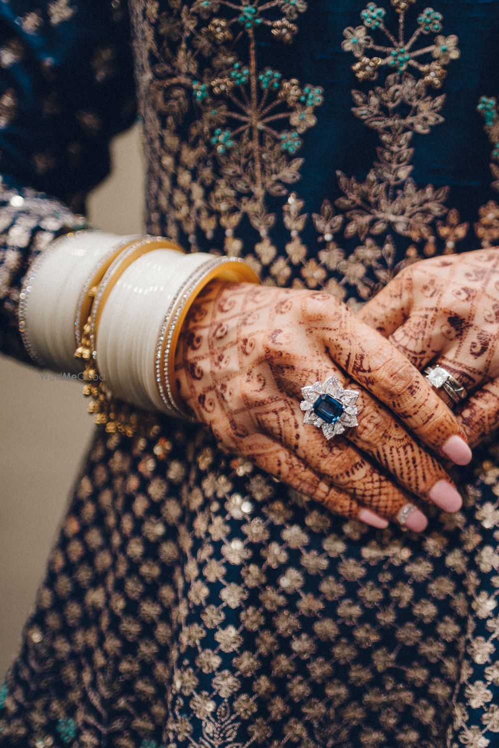 Photo of Engagement jewellery on hands with emerald ring