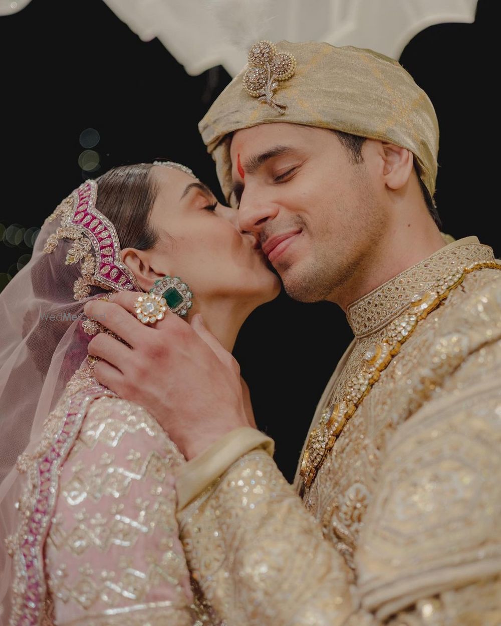 Photo of cute kiara sid portrait with bride kissing the groom