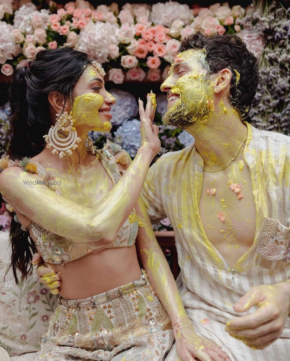 Photo of Alanna & Ivor in pastel outfits on their haldi ceremony